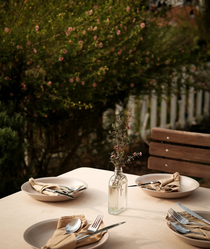 A charming outdoor table setting with tableware in a Đà Lạt garden.