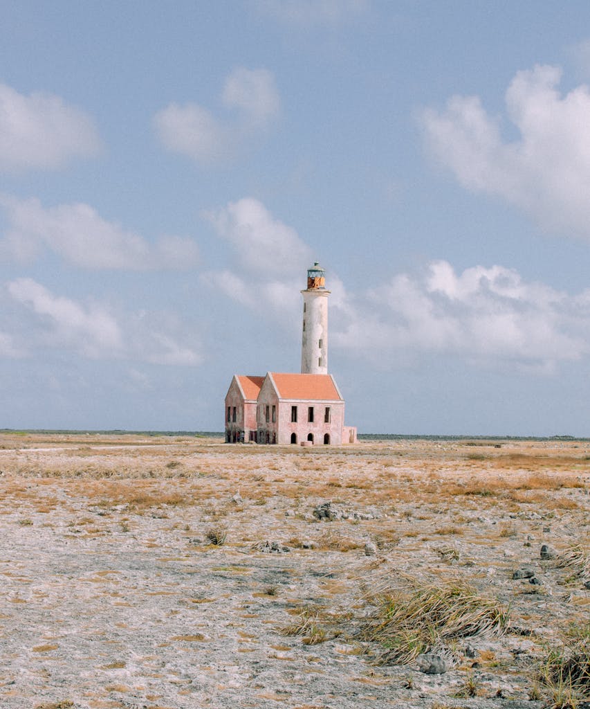 Explore the isolated beauty of an abandoned lighthouse on Klein Curacao, captured on a clear day.