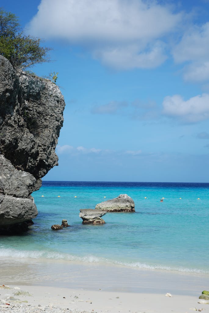 Explore the stunning coastal beauty of Curaçao with rocky shores, blue waters, and clear skies.